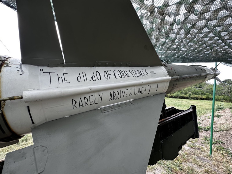 SAM (S-125) with 'The dildo of consequences rarely arrives lubed.' painted on it.