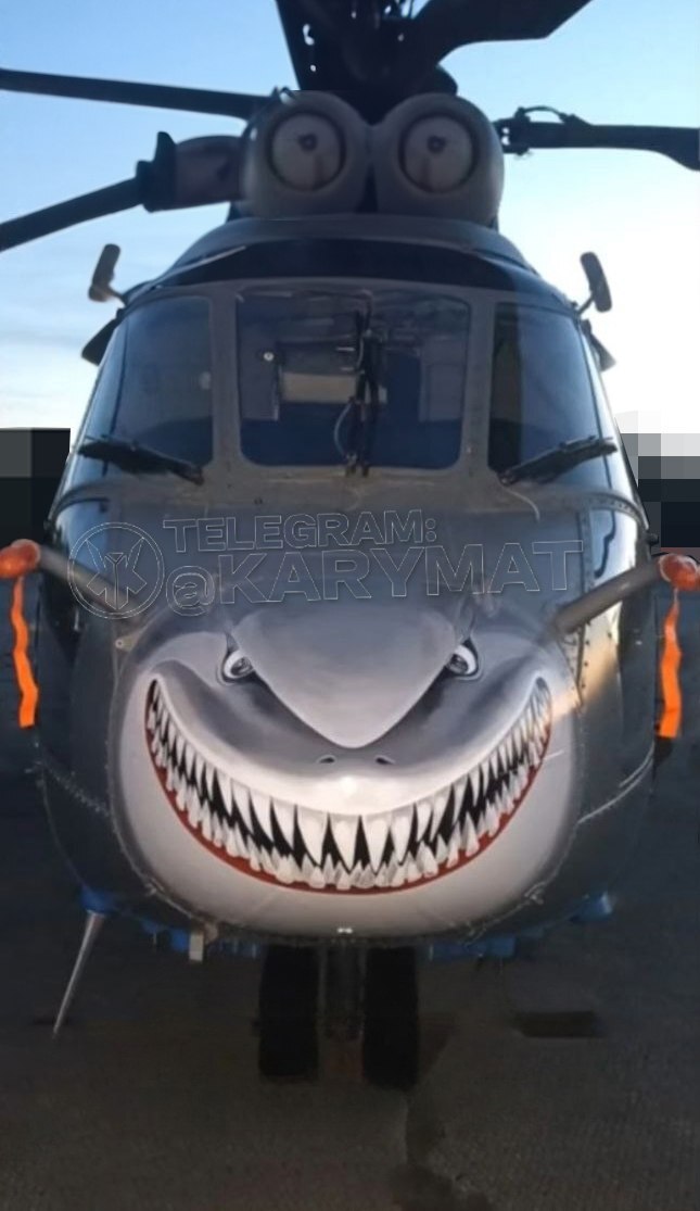A helicopter where the nose has been painted to look like a shark.
