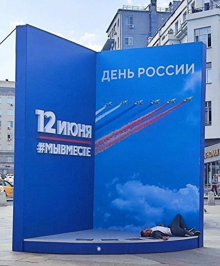A patriotic display with planes skywriting Russian colors, and there's a drunk Russian passed out at the bottom of it.