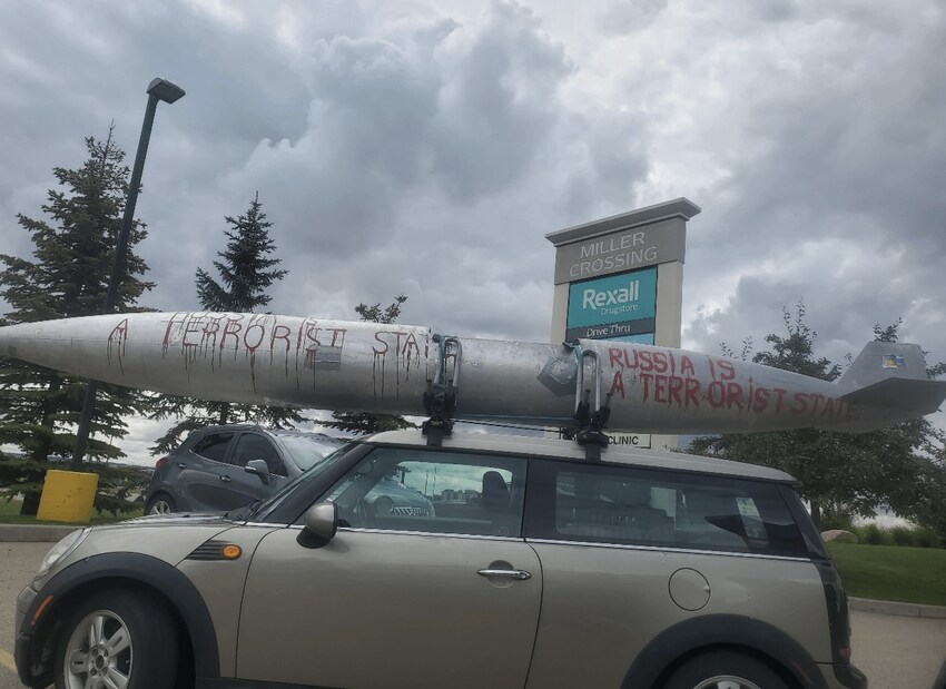 Car seen in Edmonton, Canada, with a missile on top with 'Russia is a terrorist state' painted on it.