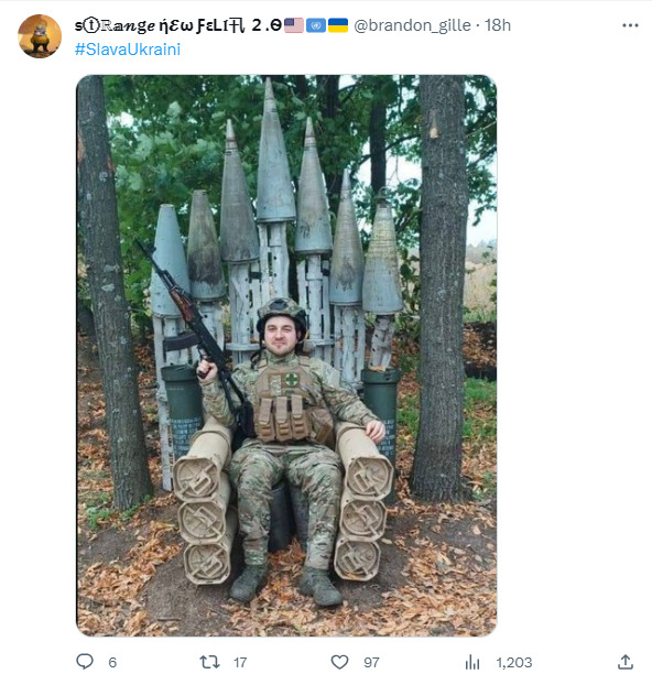 A Ukrainian soldier sits in a replica of the Iron Throme made not out of swords, but missiles.