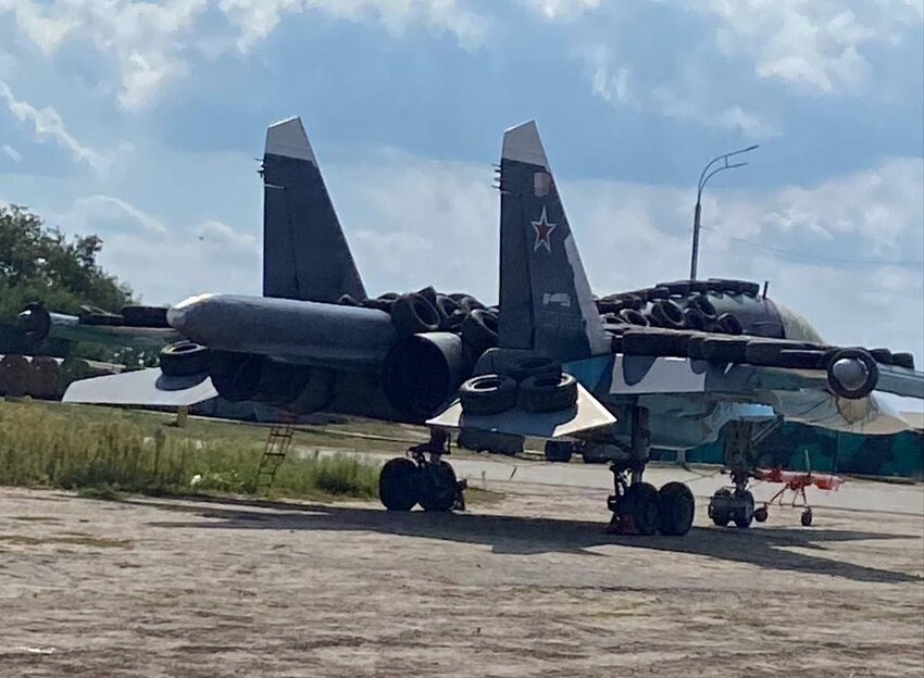 A Russian Su-34 with tires piled on its wings.