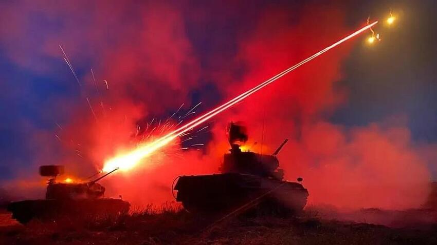 Artistic shot of a Gepard firing an antiaircraft round at night.