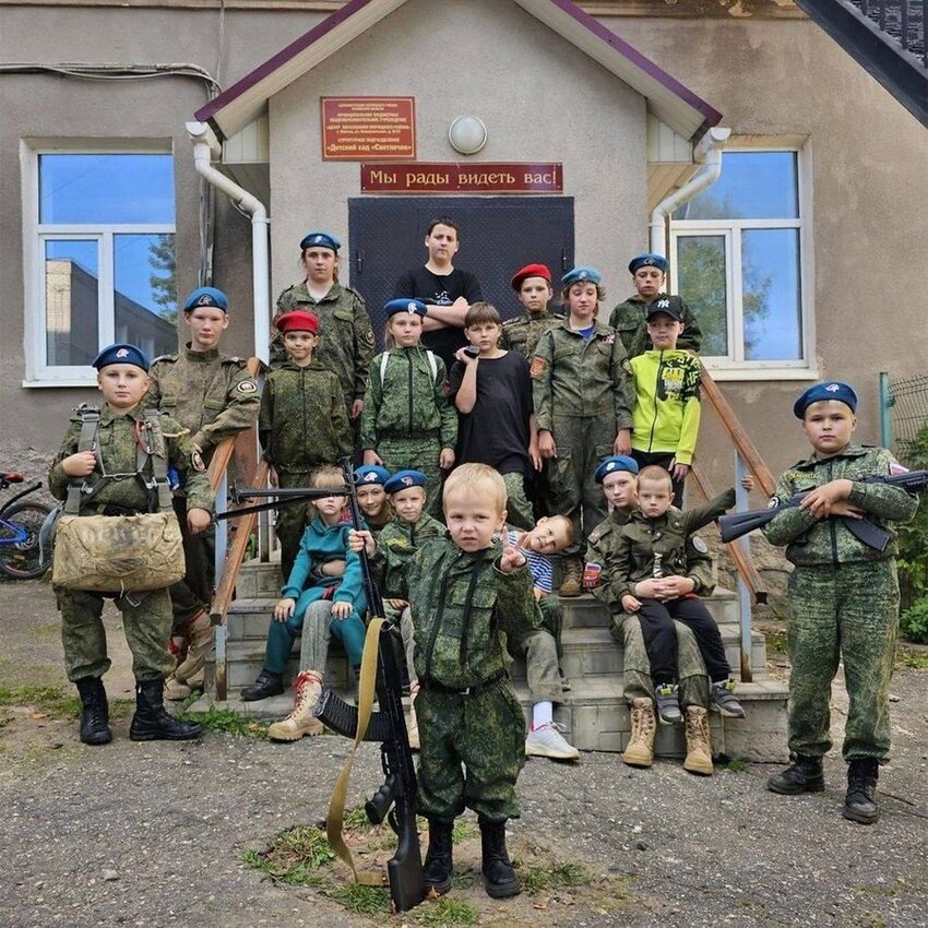 A Russian grade school where young children are wearing military gear and holding weapons.