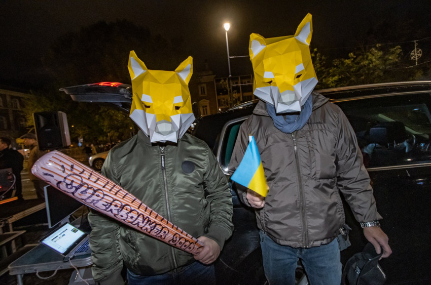 Men wearing dog masks and carrying a Superbonker 9000.