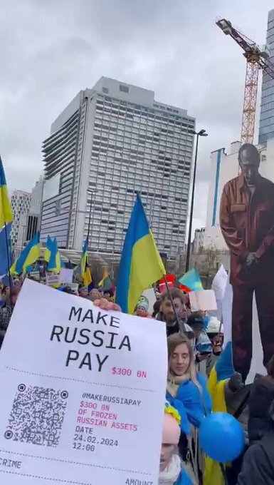 Protests in Belgium, Ukraine flags and a sign saying 'Make Russia pay'