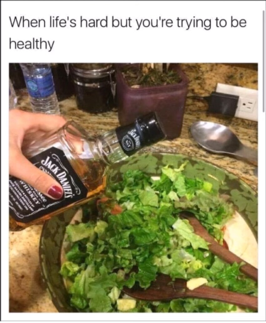 When life's hard but you're trying to be healthy: Pouring Jack Daniel's on a salad.