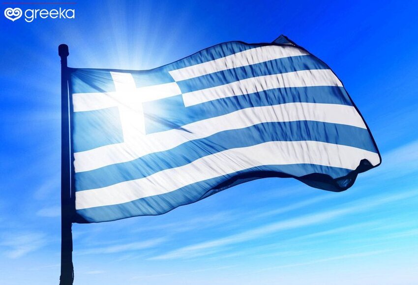 Greek flag with sun behind it.