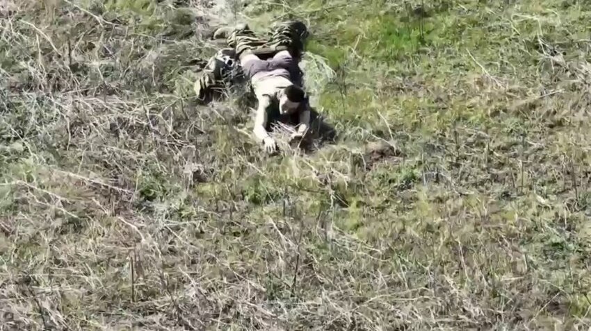 A Russian surrenders to Ukrainians.