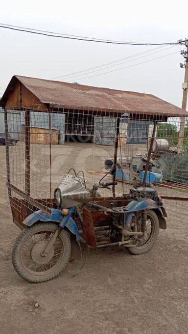 A cope cage on a motorcycle and sidecar.