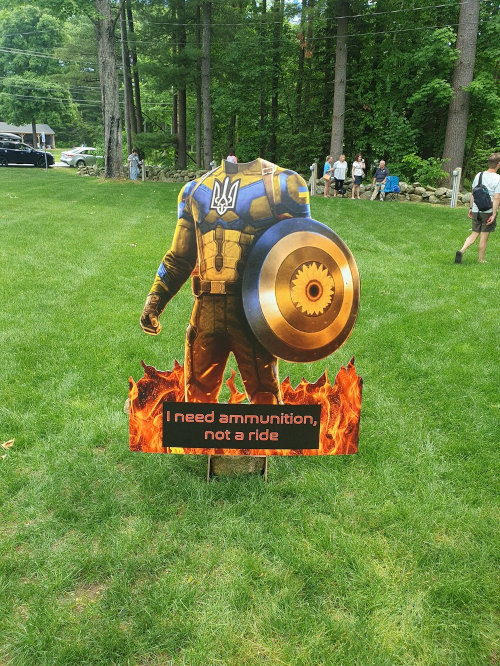 Cardboard cutout of Captain Ukraine, saying 'I need ammunition, not a ride.'