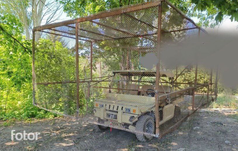 A Russian vehicle with a massive cope cage on top of it.