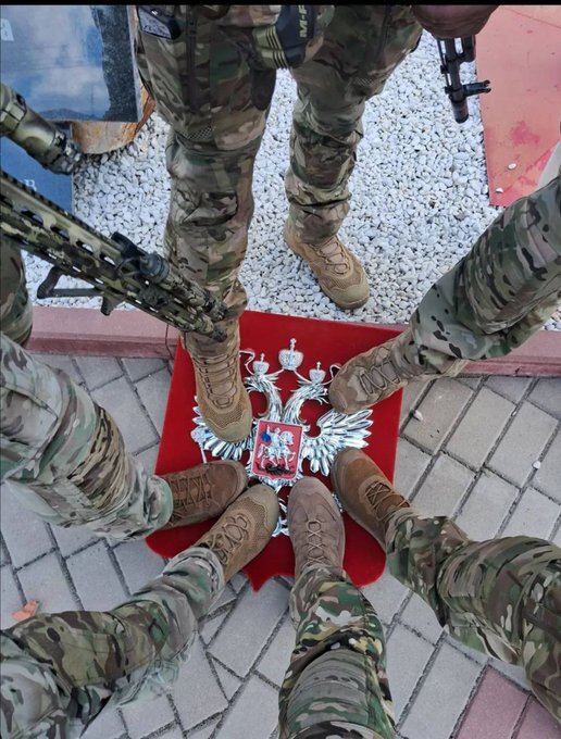 Ukrainian soldiers standing on a Russian eagle.