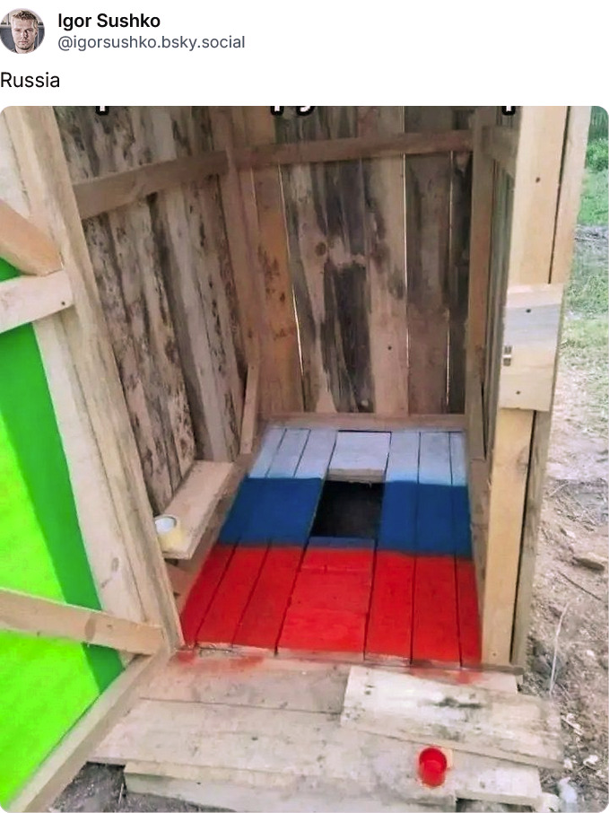 Russian outhouse floor painted in colors of the Russian flag.