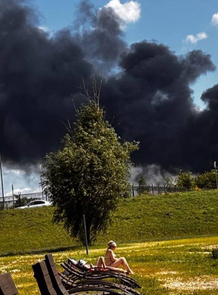 Fire in Belgorod, and a woman sunbathing near it.