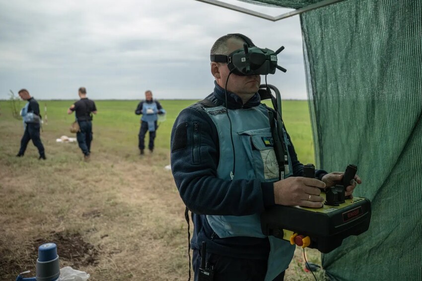 Ukrainian farmers demining with rakes and tractors.