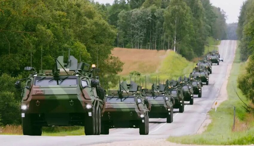A line of Latvian Patria APCs, traveling to Ukraine.